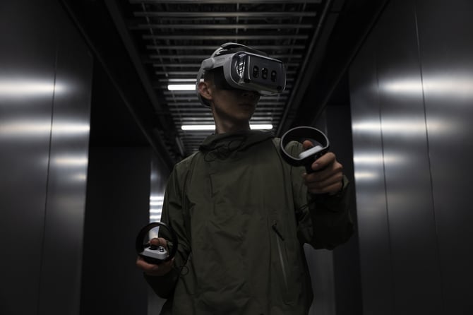 A person wearing a VR headset. Virtual reality is an example of spatial computing